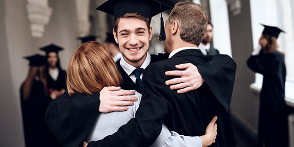 Proud graduate hugging loved ones